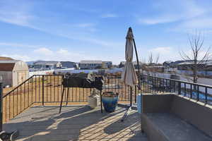 Wooden deck with a residential view, a storage shed, and an outdoor hangout area