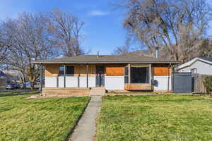 View of front of house featuring covered porch, brick siding, and a shingled roof