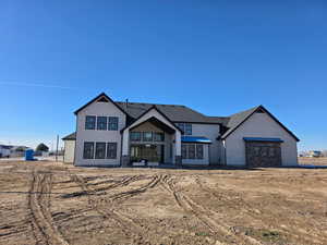 Back of house featuring stucco siding and a patio area