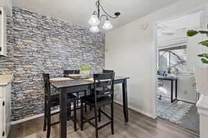 Dining room featuring a chandelier, light wood-type flooring, and ceiling fan
