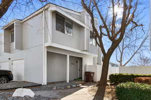 View of front of home with a balcony and an attached garage