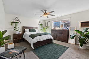 Bedroom with light colored carpet and ceiling fan