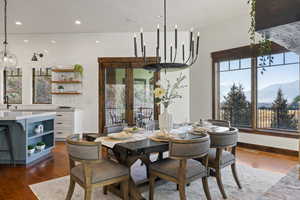 Dining room with french doors, dark wood-type flooring, a mountain view, a textured ceiling, and recessed lighting