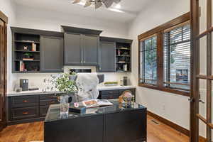 Office area featuring ceiling fan and light wood-style floors
