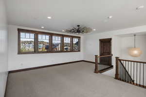 Empty room with carpet floors and recessed lighting