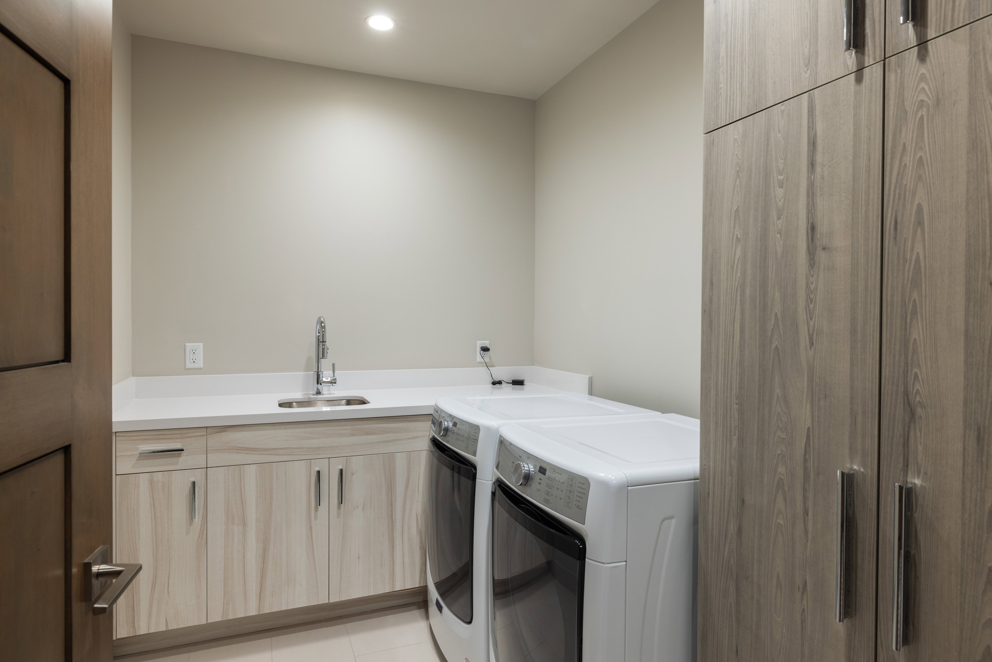 Laundry room with cabinet space, recessed lighting, and washer and dryer