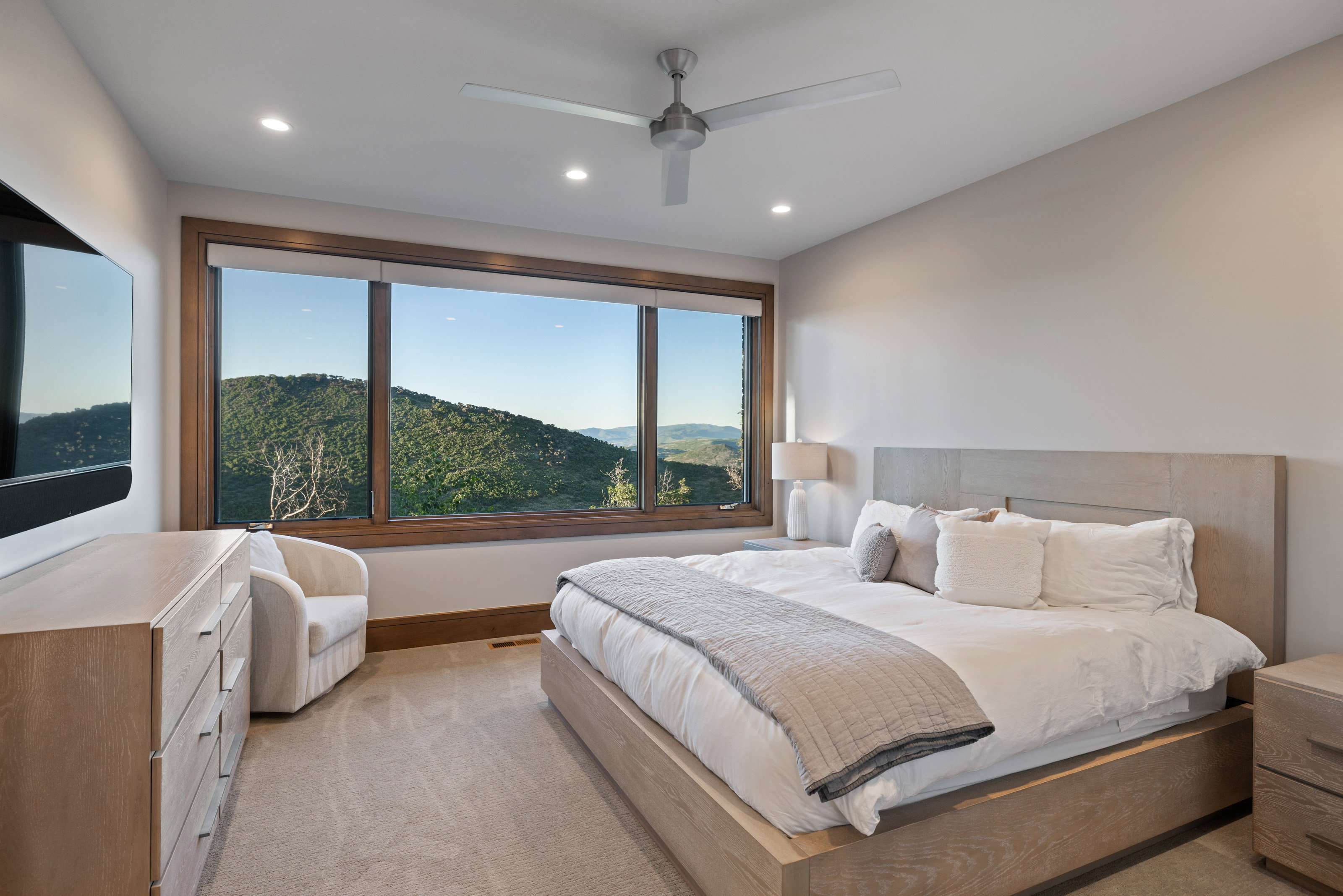 Bedroom featuring light colored carpet, a mountain view, ceiling fan, and recessed lighting