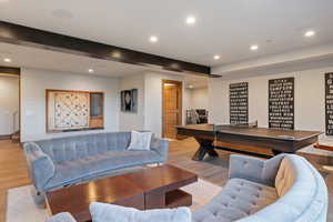 Living room featuring recessed lighting, wood finished floors, and beamed ceiling