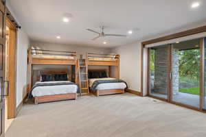 Bedroom with access to exterior, ceiling fan, light colored carpet, a barn door, and recessed lighting