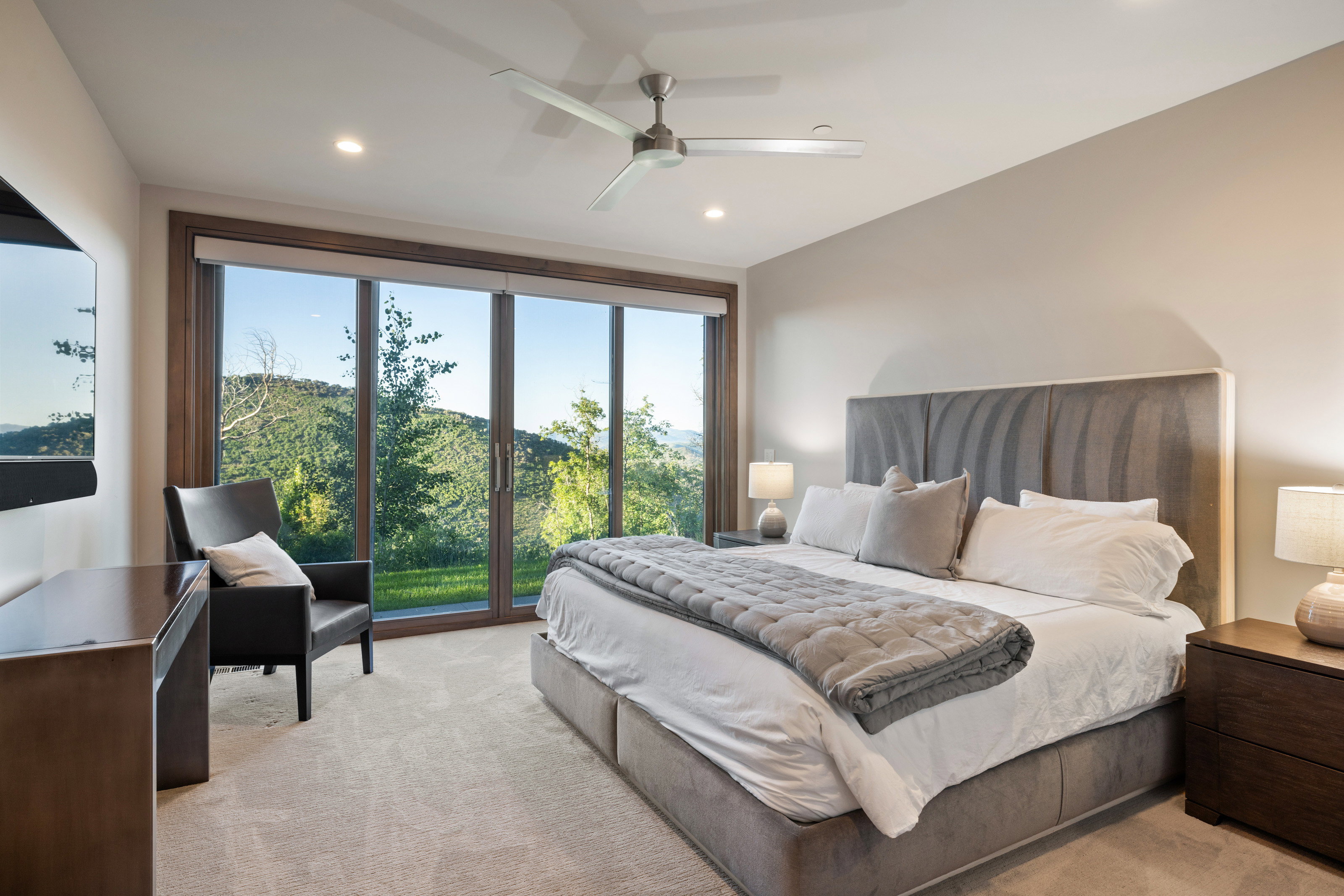 Bedroom featuring light colored carpet, ceiling fan, and recessed lighting