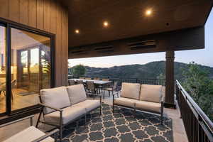 Balcony featuring an outdoor hangout area, outdoor dining area, and a mountain view