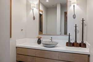 Bathroom with vanity and recessed lighting