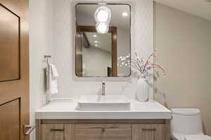 Bathroom with vanity and recessed lighting