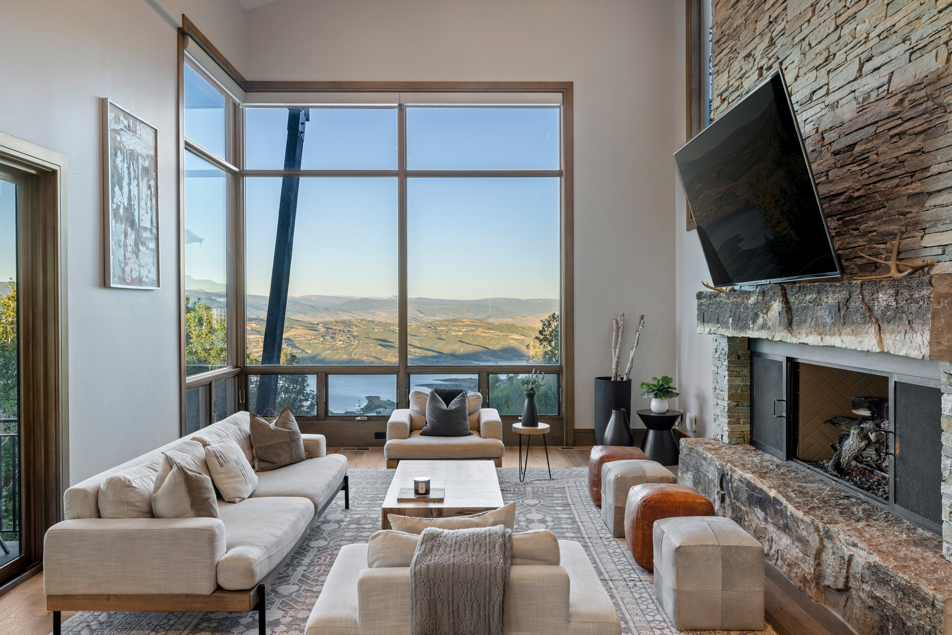 Living area with wood finished floors and a stone fireplace
