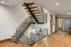 Staircase featuring recessed lighting and hardwood / wood-style floors