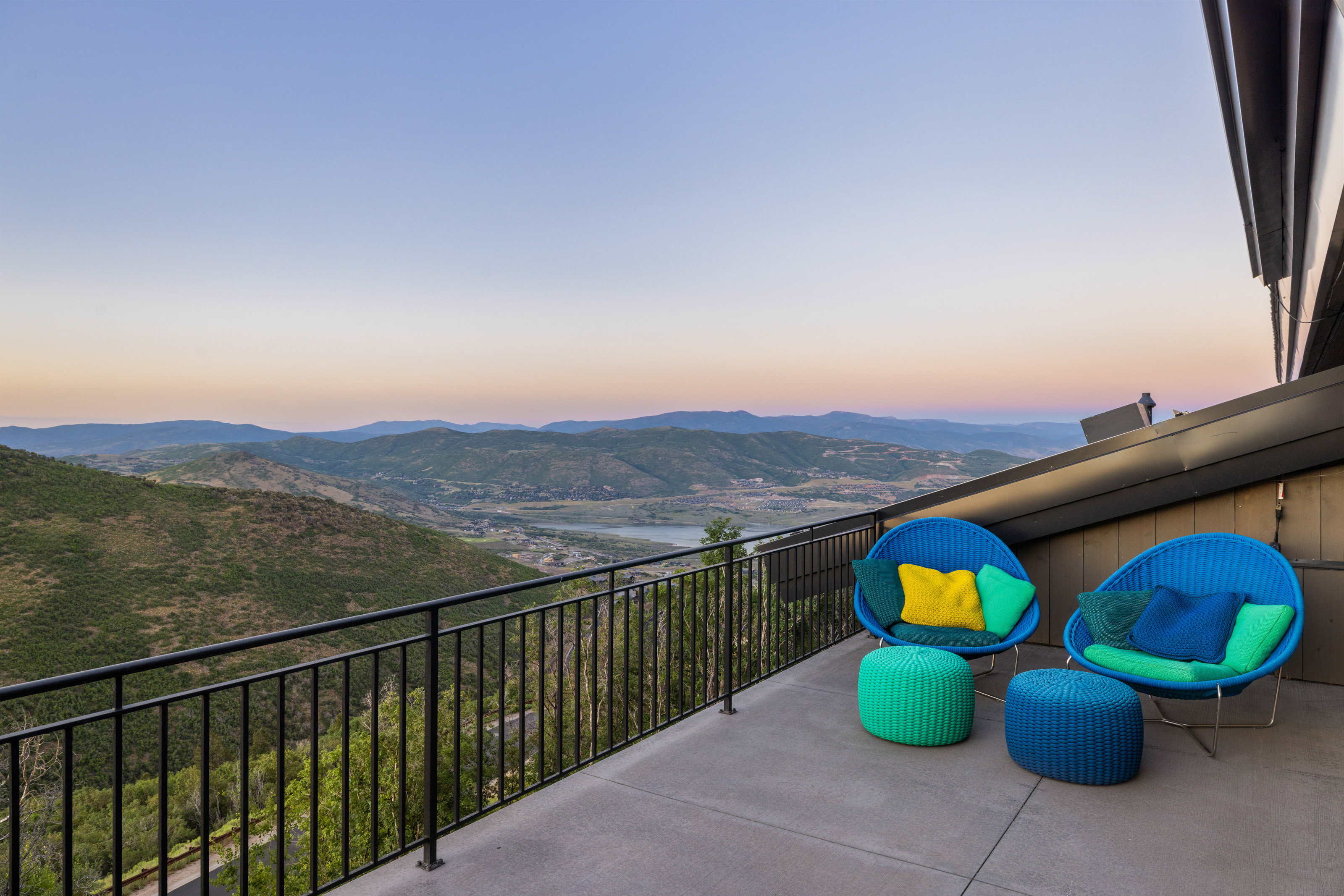 Balcony at dusk featuring a mountain view and a patio
