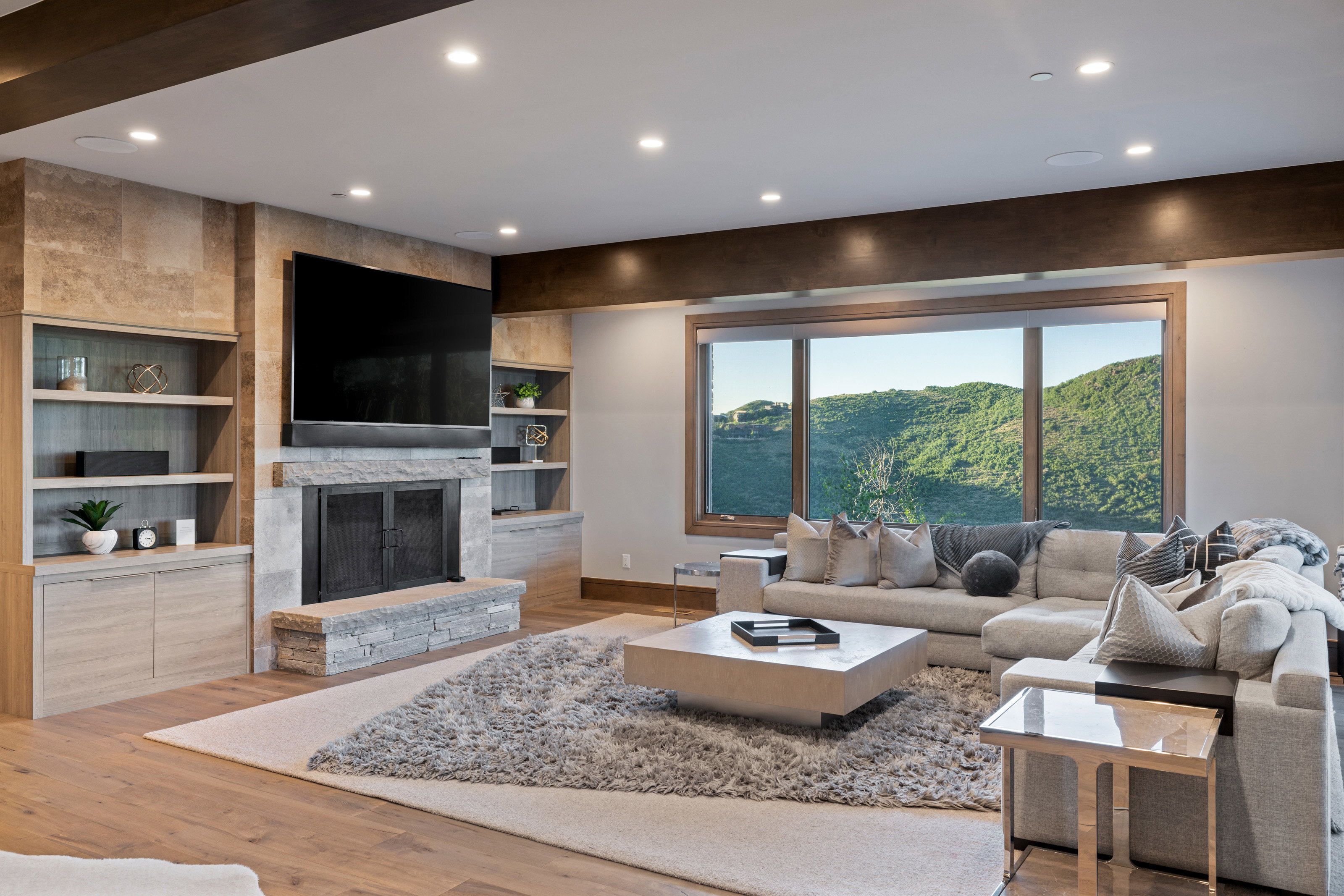 Living area featuring wood finished floors, recessed lighting, a fireplace, and built in shelves