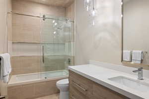 Bathroom with vanity and tiled shower / bath