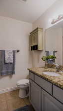 Bathroom with vanity and light tile patterned floors