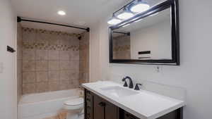 Full bath featuring vanity, shower / washtub combination, and recessed lighting