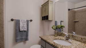 Bathroom with vanity and a tile shower