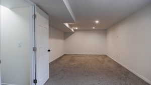 Finished below grade area featuring carpet floors and recessed lighting