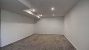 Empty room with carpet flooring and recessed lighting