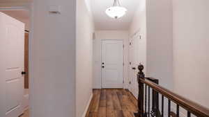 Corridor with dark wood finished floors and baseboards