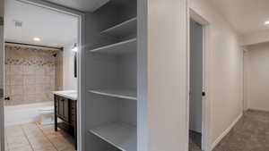 Bathroom with vanity, recessed lighting, and shower / bath combination