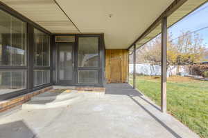 View of exterior entry featuring a patio area