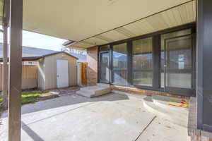 View of patio / terrace featuring a storage shed