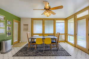 Dining area featuring light flooring and ceiling fan