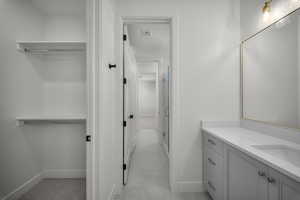 Bathroom with vanity, a shower stall, and a textured ceiling