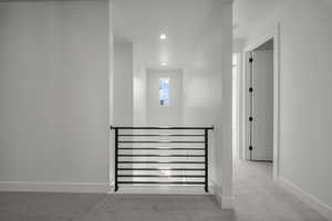 Corridor featuring carpet floors and recessed lighting