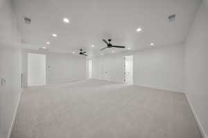 Spare room featuring light carpet, recessed lighting, and a ceiling fan
