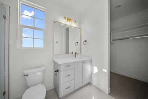 Full bathroom with plenty of natural light and vanity