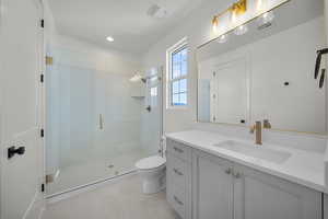 Bathroom with vanity, a shower stall, and recessed lighting