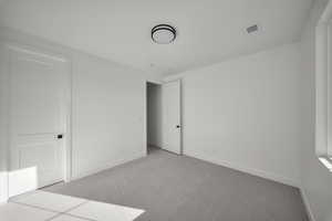 Unfurnished bedroom featuring carpet floors and baseboards