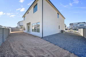 View of property exterior with a fenced backyard, stucco siding, and a patio area
