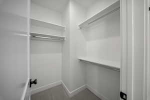 Walk in closet with carpet floors