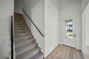 Entrance foyer with light wood-type flooring and stairs