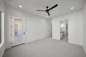Unfurnished bedroom with light carpet, a ceiling fan, recessed lighting, and connected bathroom
