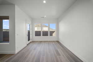 Spare room with light wood-style floors and recessed lighting