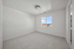 Empty room with light colored carpet