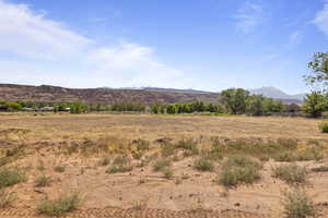 View of mountain backdrop with rural landscape