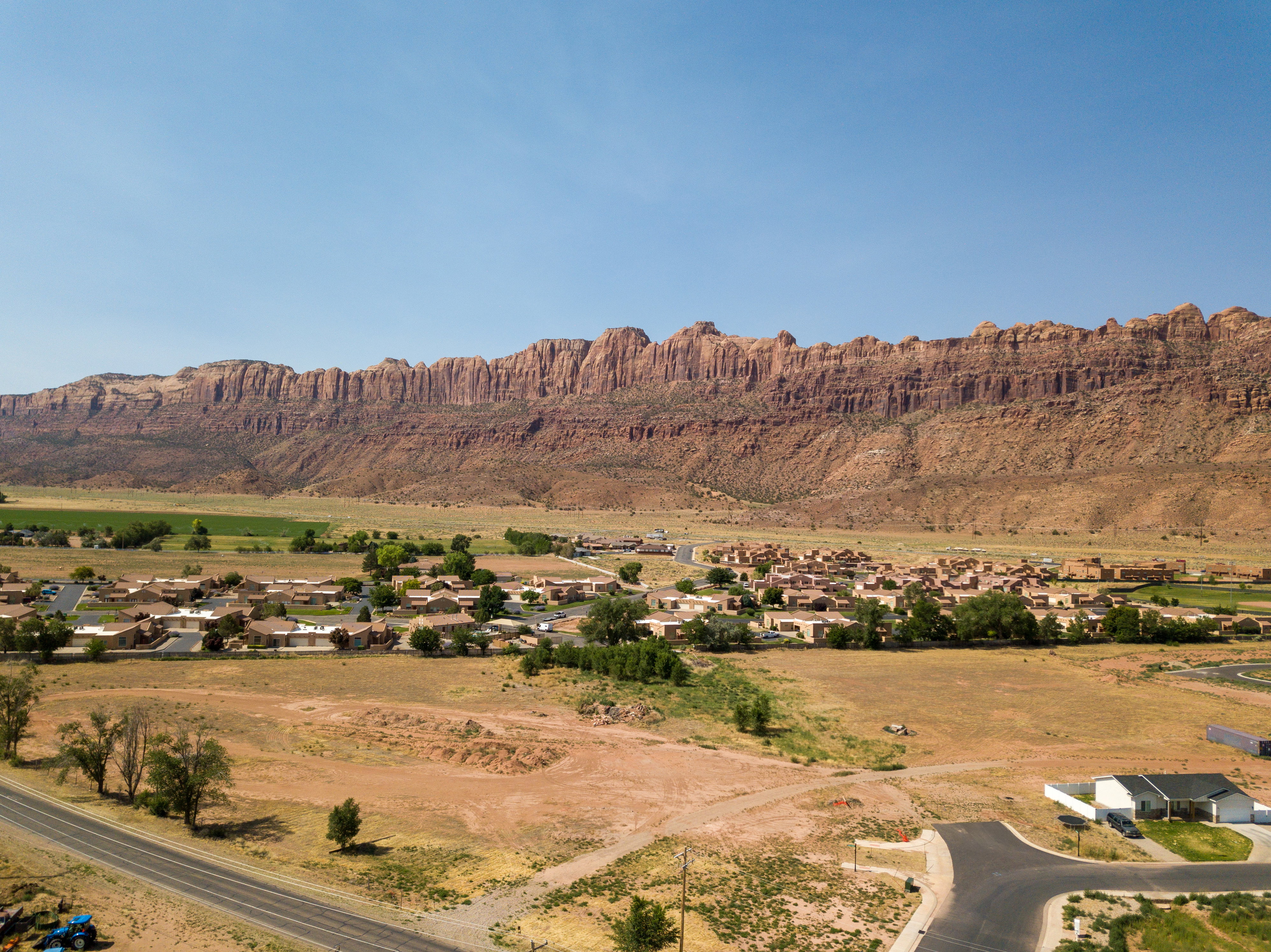 View of mountain backdrop with nearby suburban area and rural landscape
