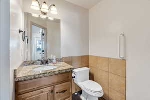 Bathroom with tile walls and vanity