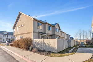 View of property exterior with stucco siding and a residential view
