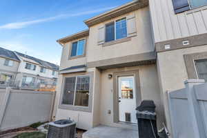 View of exterior entry with stucco siding and a patio area