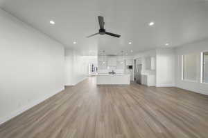 Unfurnished living room with recessed lighting, light wood-style flooring, and ceiling fan